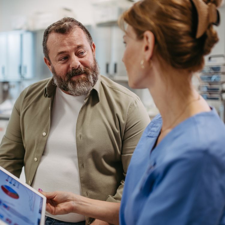 A doctor with Louisiana Pain Specialist showing a patient what the spine looks like.